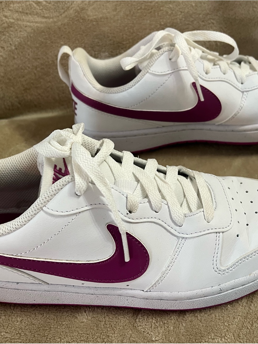 Nike Women's White Sneakers with Purple Swoosh Accent